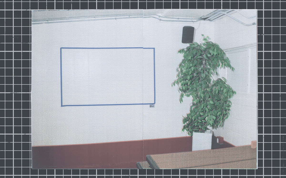 red picnic tables. a rectangle in blue tape on the wall